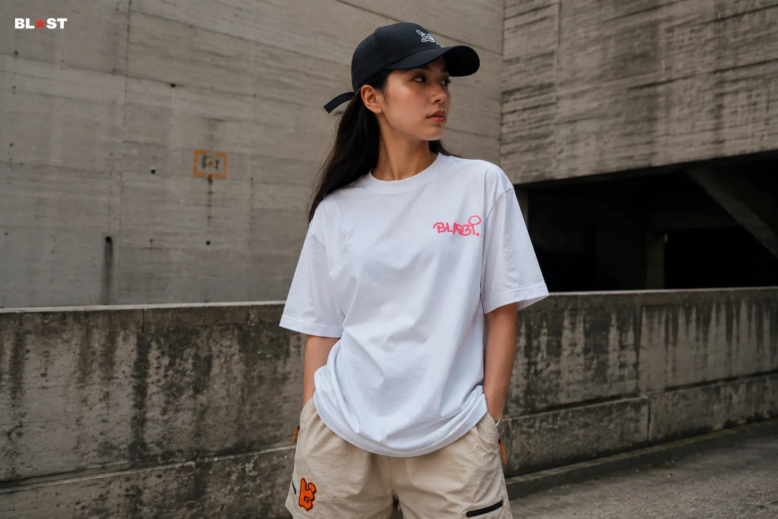 Model in the bone tee and bone tech shorts against a concrete wall