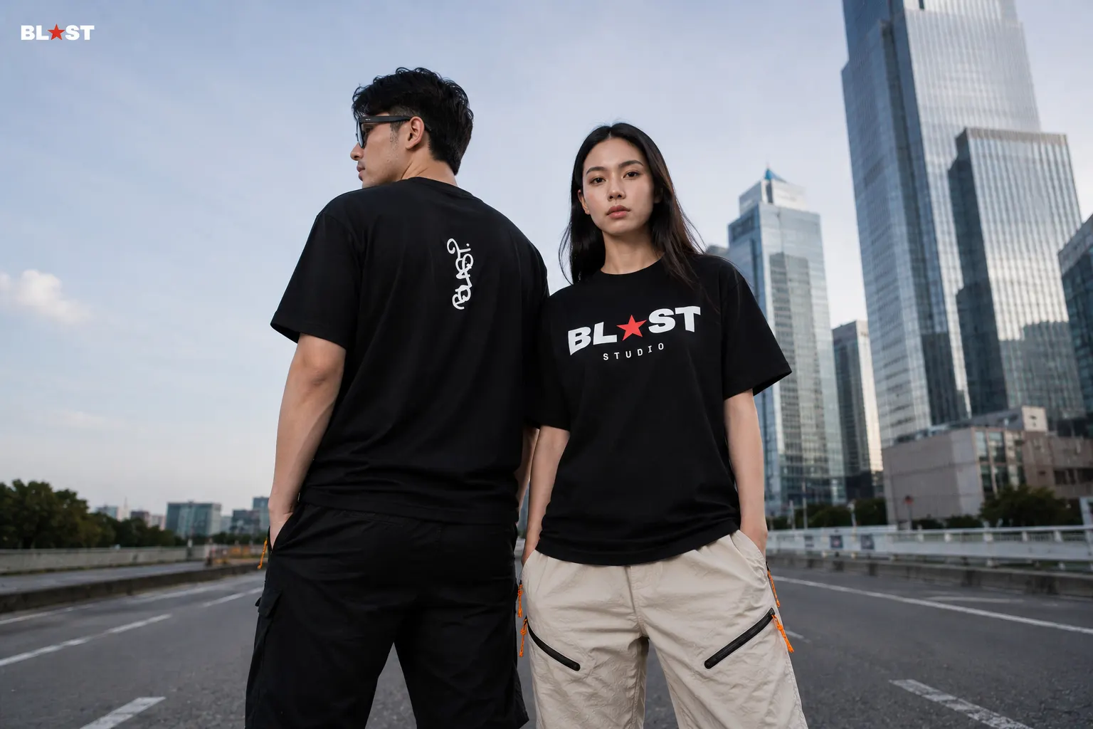 Two models showing the ink tee front and back graphics on an empty overpass